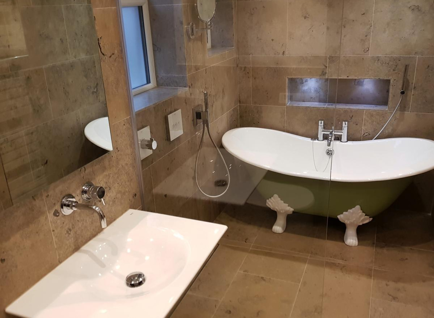Completed wet-room shower with natural stone tiles